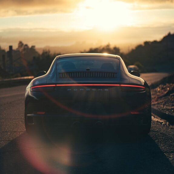 Porsche driving into the sunset